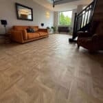 Regal Timber Basket Weave LVT flooring in a living room with a leather sofa