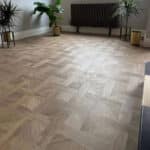 Regal Timber Basket Weave LVT flooring in a living room with plants